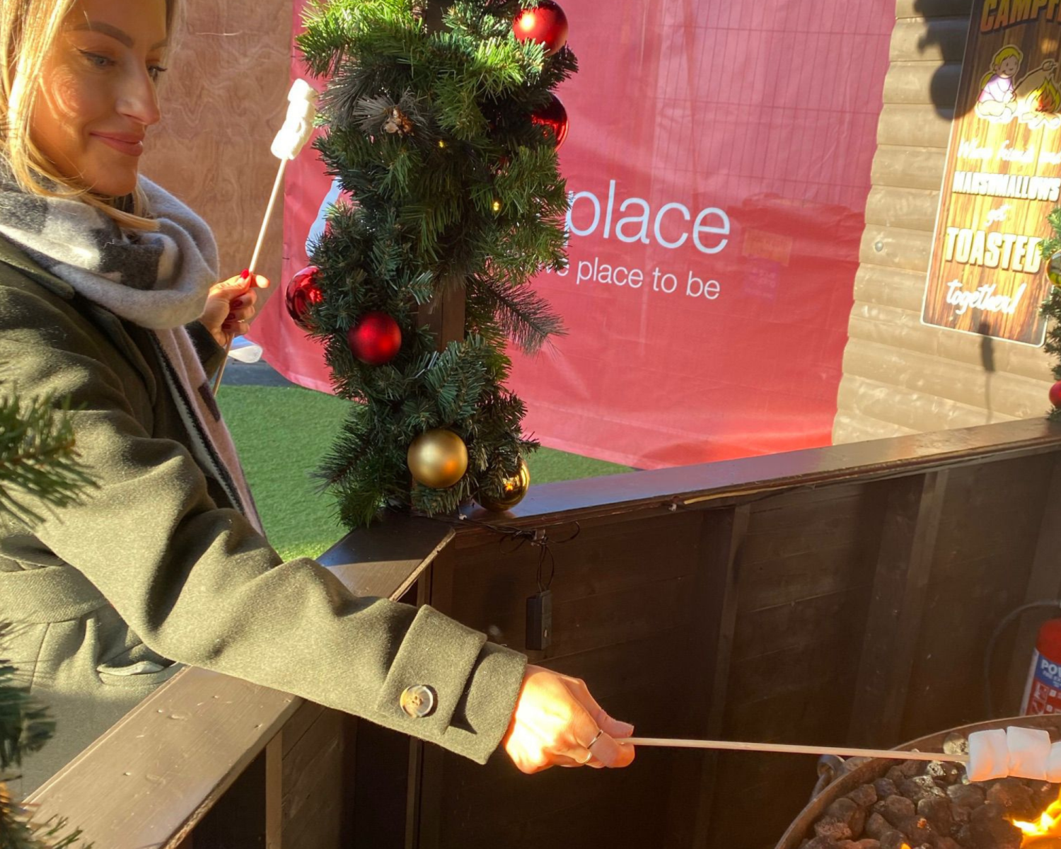 Rachel Ivie toasting a marshmallow at the Belfast Christmas Market